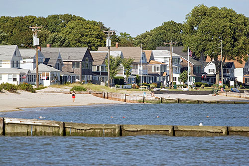 A New England beach house with crashing waves.